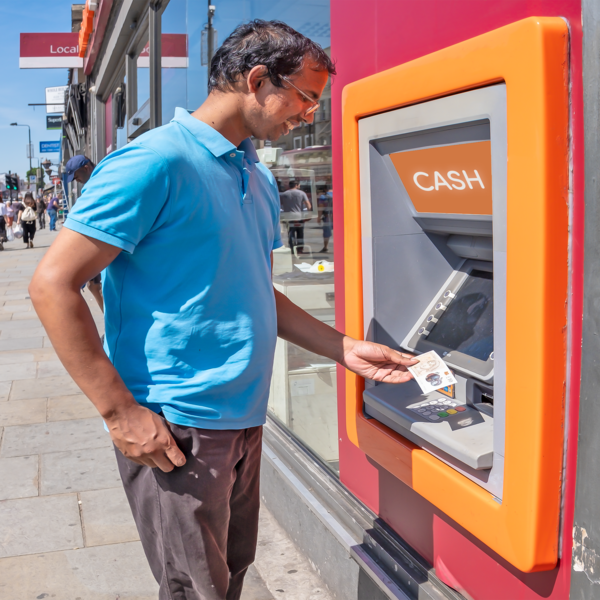 Person taking money out at a cash machine